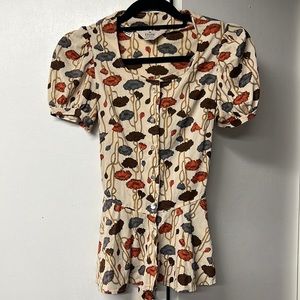 Cap sleeve blouse with a bit of a western feel in browns and orange tones.